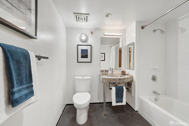 bathroom with baseboards, shower / tub combination, toilet, and tile patterned floors