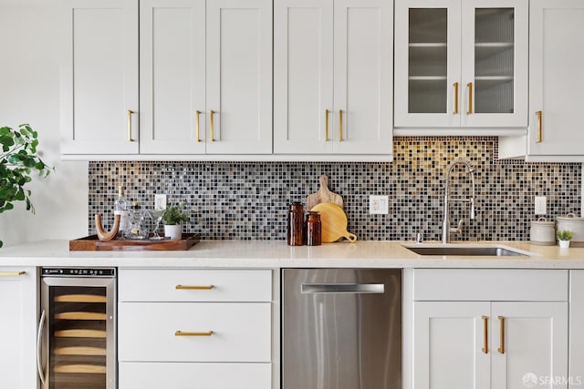 246 Ralston St, San Francisco, CA 94132 - kitchen with stainless steel dishwasher, beverage cooler, light countertops, and white cabinetry