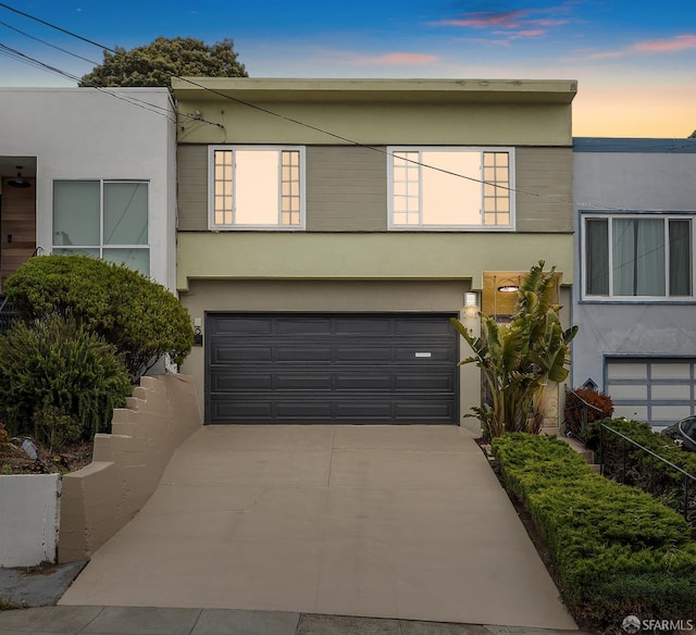 246 Ralston St, San Francisco, CA 94132 - view of front of property with stucco siding, an attached garage, and concrete driveway