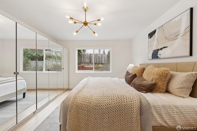 246 Ralston St, San Francisco, CA 94132 - bedroom with a chandelier, multiple windows, and light wood finished floors