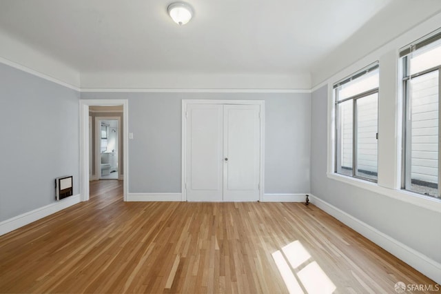 unfurnished bedroom featuring a closet and light wood-type flooring