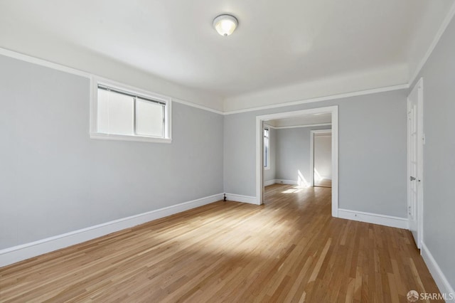 spare room featuring crown molding and wood-type flooring