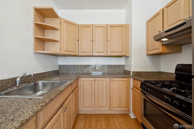 kitchen with light brown cabinetry, stone countertops, black range with gas cooktop, light hardwood / wood-style floors, and sink