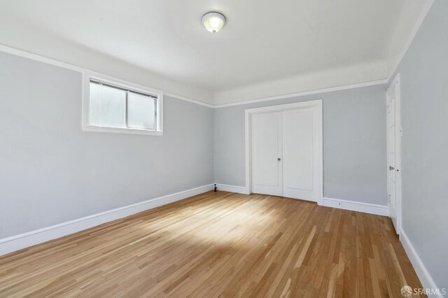 unfurnished bedroom featuring a closet and light wood-type flooring