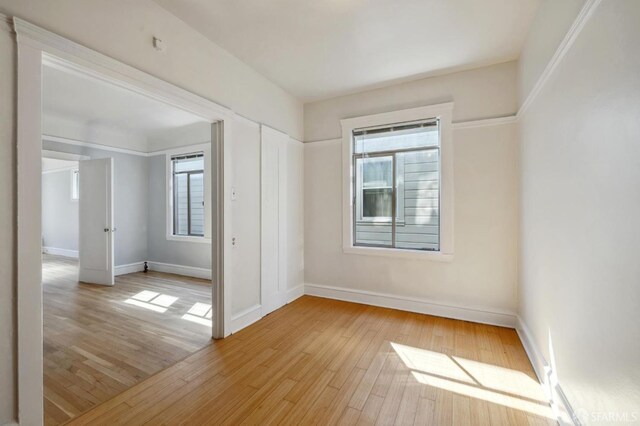 unfurnished room with light hardwood / wood-style flooring