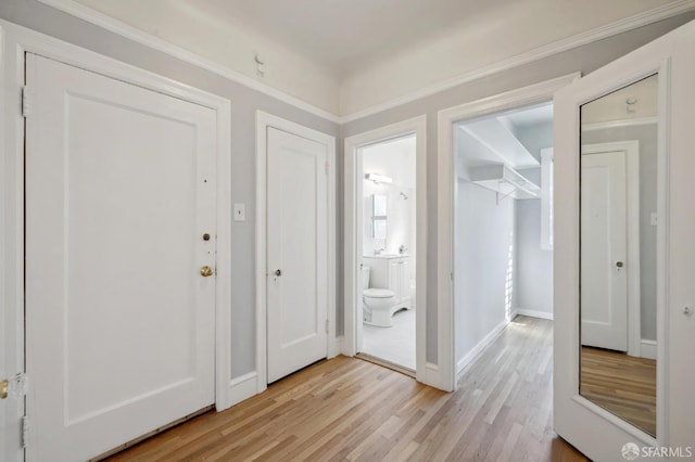 foyer featuring light hardwood / wood-style flooring and ornamental molding