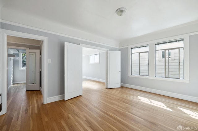 interior space with light hardwood / wood-style floors and crown molding