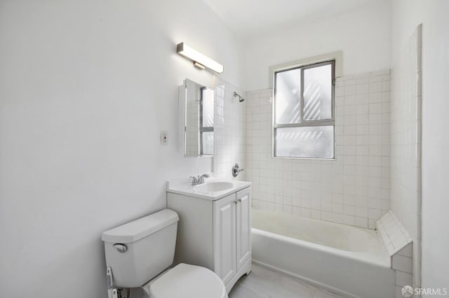 full bathroom with vanity, tiled shower / bath combo, and toilet