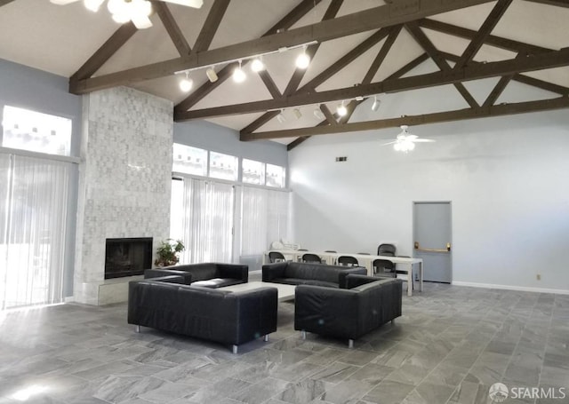 living room featuring high vaulted ceiling, ceiling fan, beamed ceiling, and a fireplace