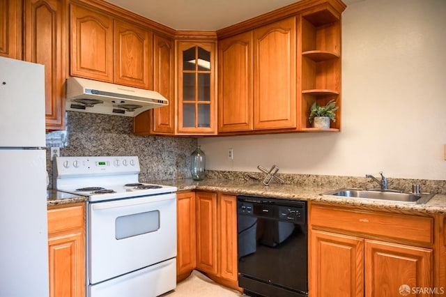 kitchen featuring white appliances, light stone counters, sink, and backsplash