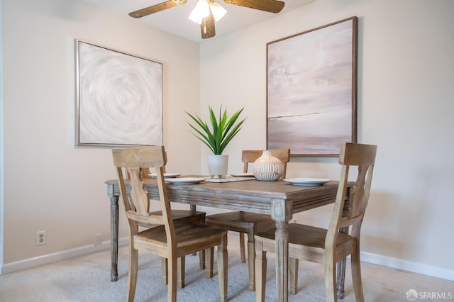 dining room featuring ceiling fan and light colored carpet