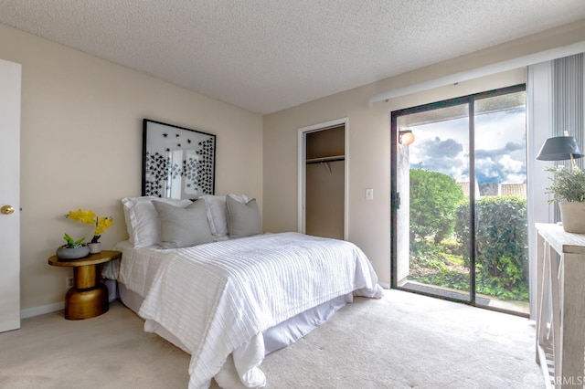 bedroom featuring a closet, a textured ceiling, and light colored carpet