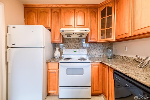 kitchen featuring backsplash, white appliances, and light stone countertops