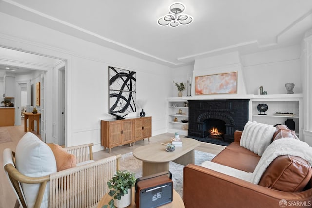 living area with a fireplace and light wood-style floors
