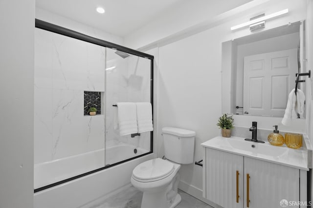 full bathroom with marble finish flooring, vanity, bath / shower combo with glass door, and toilet