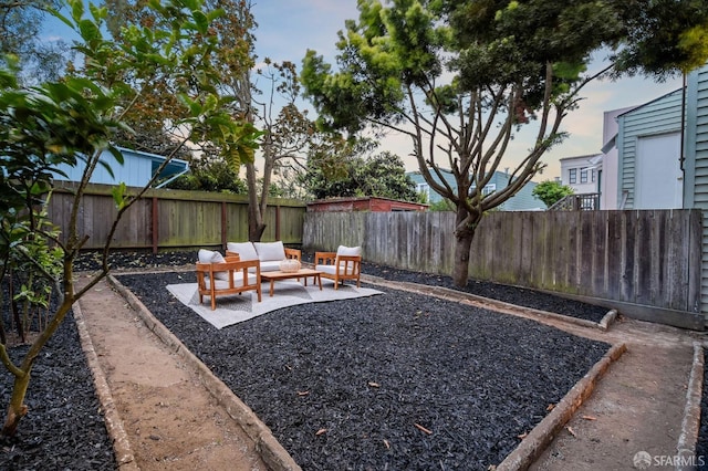 fenced backyard featuring an outdoor living space and a patio