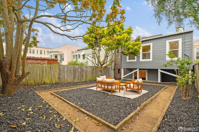 view of yard featuring an outdoor hangout area, fence, a patio, and a garden