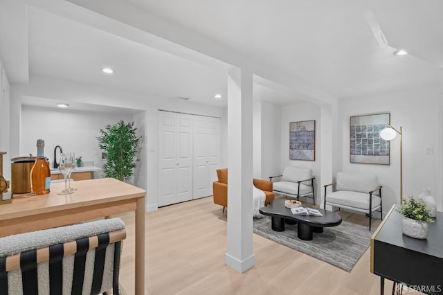 living area with light wood finished floors, recessed lighting, and baseboards