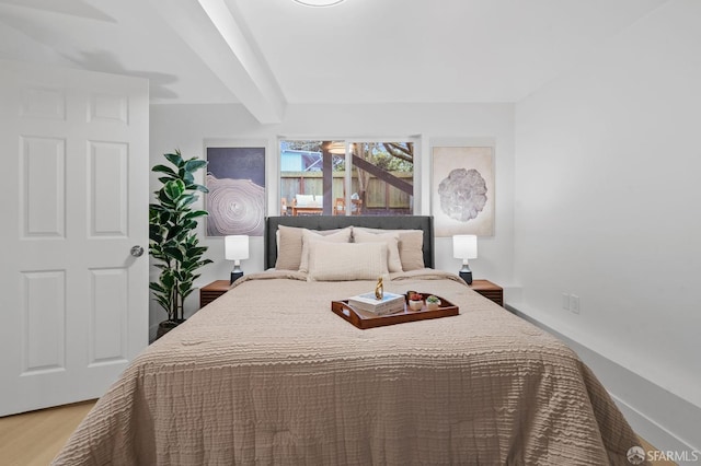 bedroom with wood finished floors and baseboards