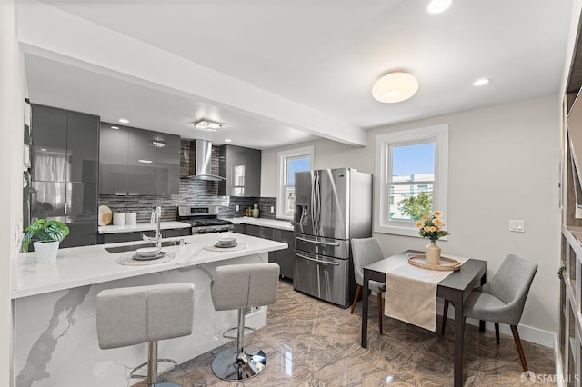 74 Crane St, San Francisco, CA 94124 - kitchen with appliances with stainless steel finishes, wall chimney range hood, modern cabinets, a sink, and a breakfast bar area