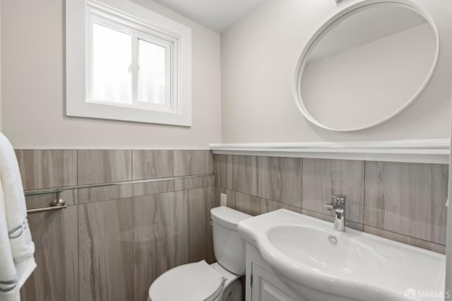 74 Crane St, San Francisco, CA 94124 - half bath with tile walls, toilet, vanity, and a wainscoted wall
