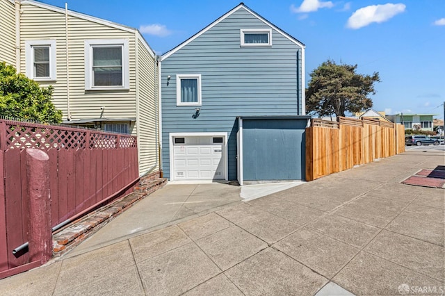 74 Crane St, San Francisco, CA 94124 - view of home's exterior featuring concrete driveway and a garage
