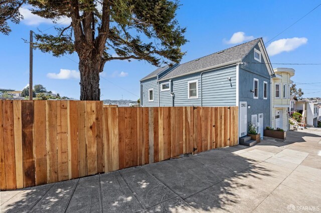74 Crane St, San Francisco, CA 94124 - view of side of home featuring a shingled roof