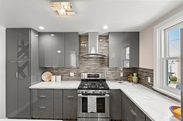 74 Crane St, San Francisco, CA 94124 - kitchen featuring gray cabinets, stainless steel gas range oven, wall chimney exhaust hood, modern cabinets, and tasteful backsplash