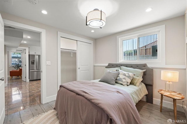 74 Crane St, San Francisco, CA 94124 - bedroom with stainless steel fridge, a closet, baseboards, recessed lighting, and light wood finished floors