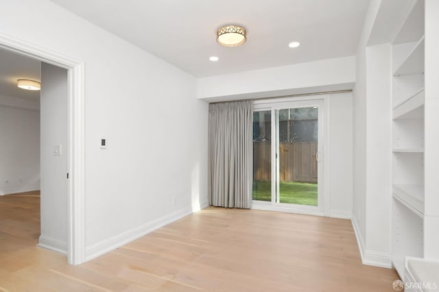 unfurnished room featuring light hardwood / wood-style floors