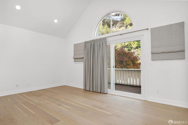 unfurnished living room with light hardwood / wood-style flooring and high vaulted ceiling