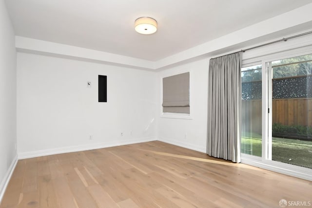 spare room with light hardwood / wood-style flooring