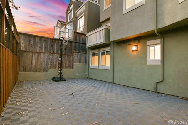 patio terrace at dusk with basketball court