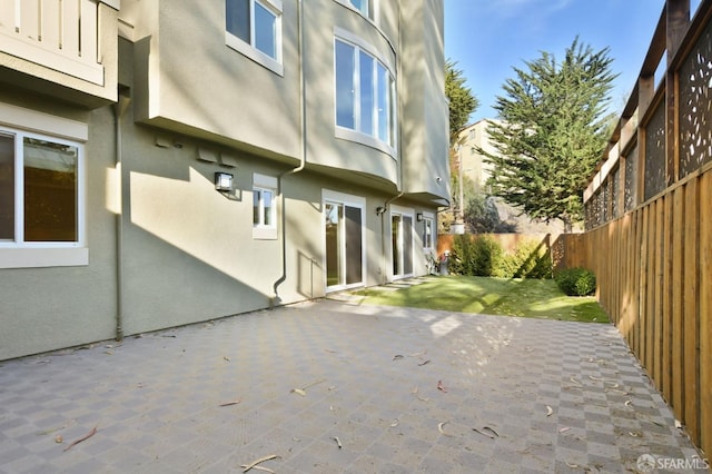 view of side of home featuring a patio