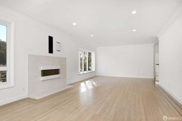 unfurnished living room with light hardwood / wood-style floors and ornamental molding