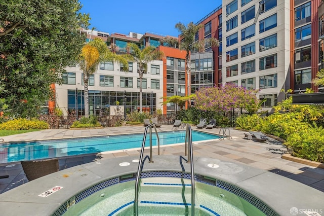 view of swimming pool featuring a community hot tub