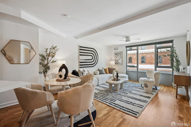 living room featuring ceiling fan and light hardwood / wood-style flooring