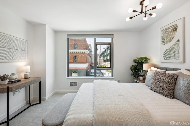 carpeted bedroom with an inviting chandelier