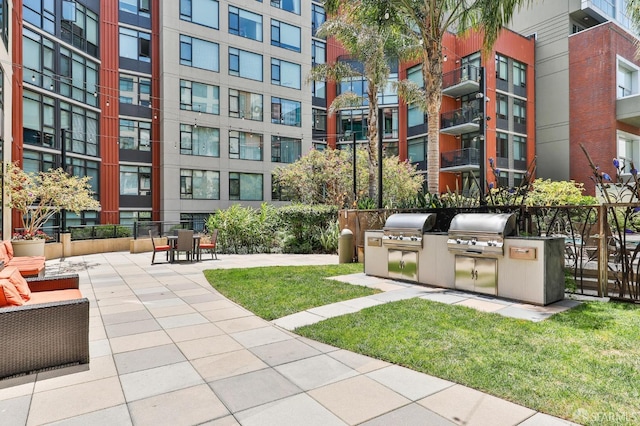 view of community with exterior kitchen and a patio area