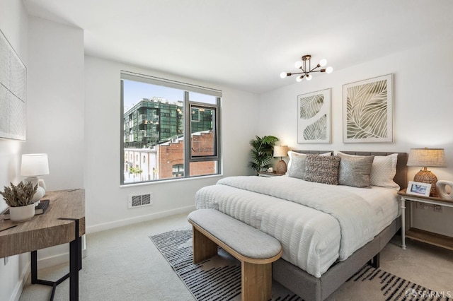 bedroom with light carpet and a notable chandelier