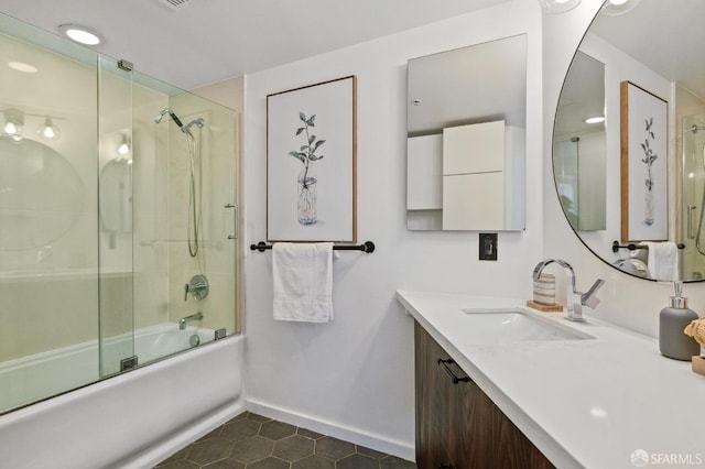 bathroom featuring bath / shower combo with glass door, vanity, and tile patterned floors