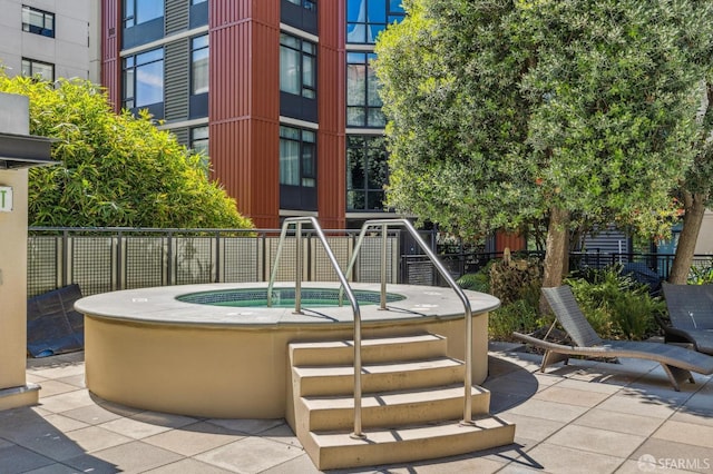 view of pool featuring a patio area and a community hot tub