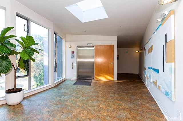 hall featuring elevator and a skylight