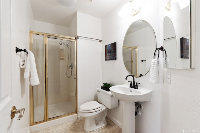 bathroom with tile patterned flooring, sink, a shower with shower door, and toilet