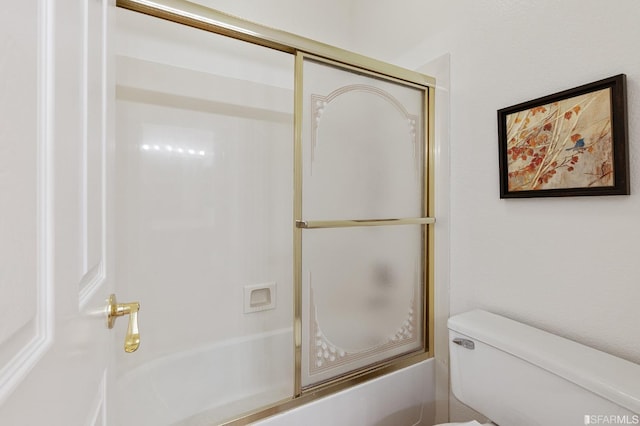 bathroom with enclosed tub / shower combo and toilet