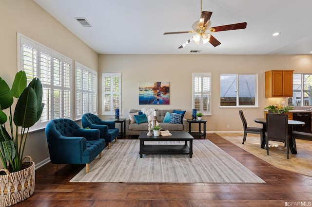 living room featuring dark hardwood / wood-style floors and ceiling fan