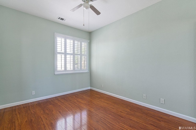 empty room featuring hardwood / wood-style flooring and ceiling fan