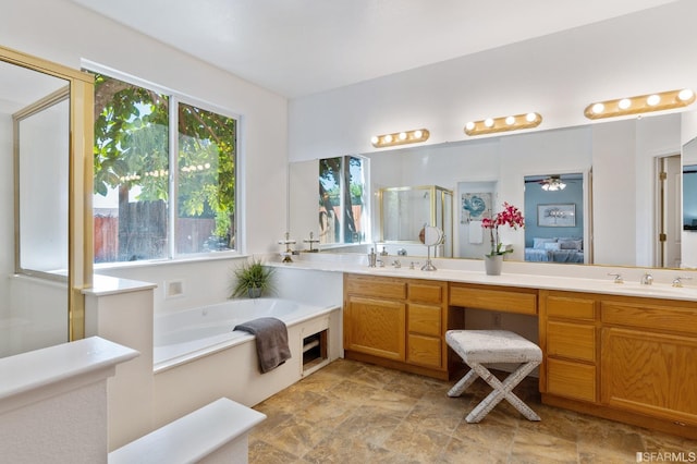 bathroom featuring vanity and shower with separate bathtub