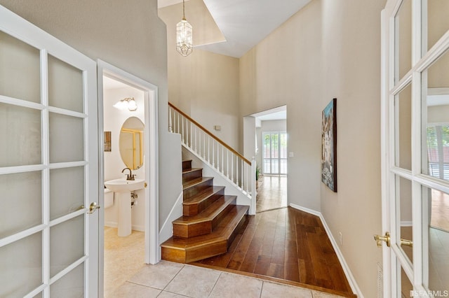 tiled entryway featuring french doors and a high ceiling