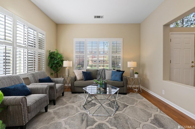 living room featuring plenty of natural light and light hardwood / wood-style floors